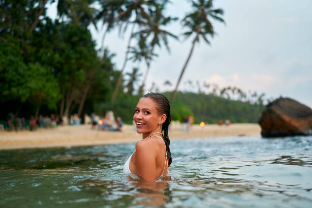 Woman enjoying the water with perfectly intact makeup, demonstrating waterproofing techniques.