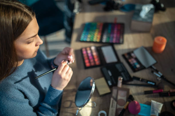  Makeup artist using a sharpener to sharpen eyeliner pencil

